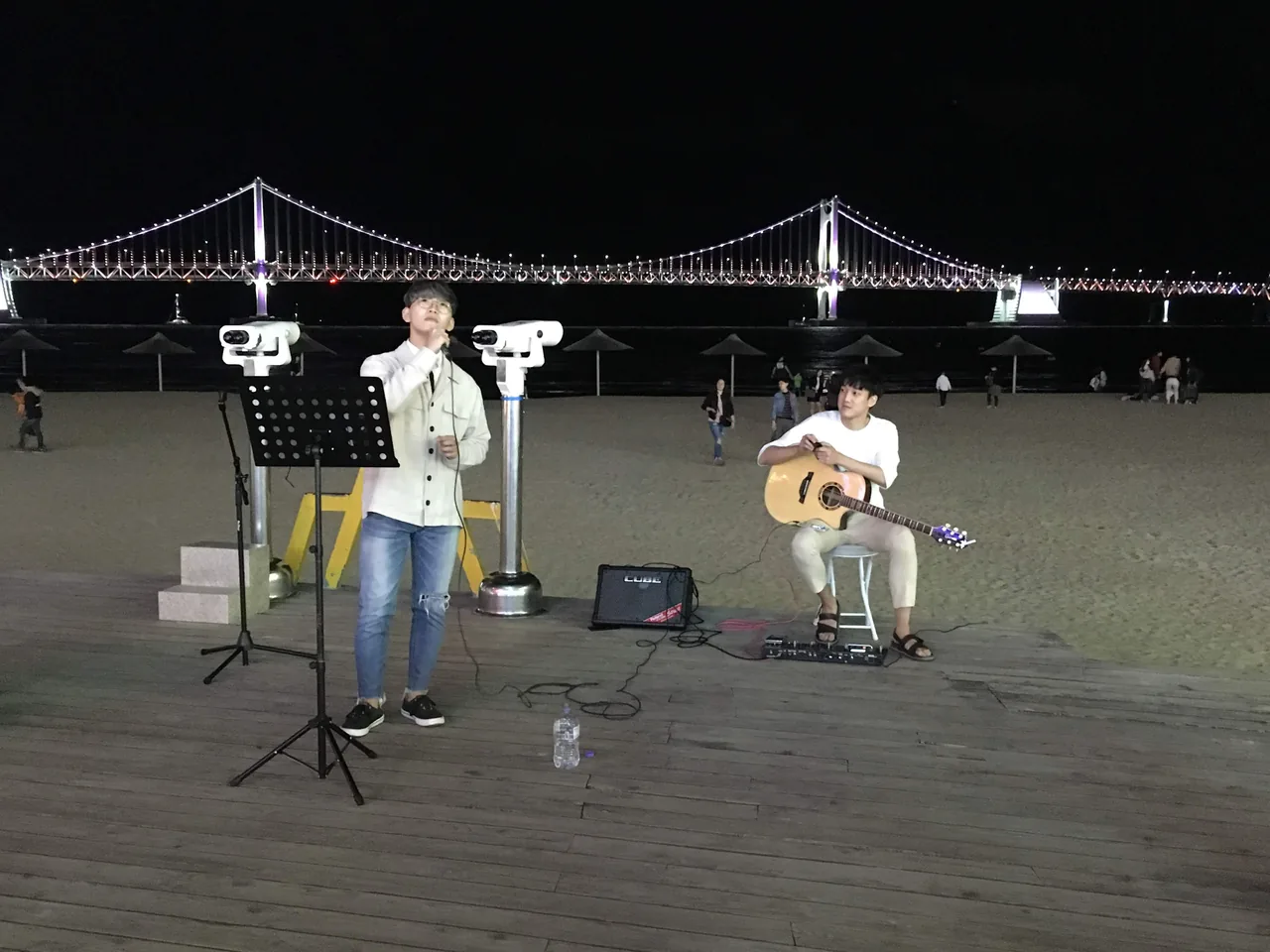 Street musicians performing on Gwangalli Beach at night with the bridge behind Street musicians performing on Gwangalli Beach at night with the bridge behind