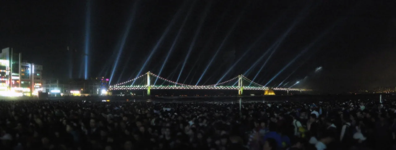 Fireworks bursting over the lit Gwangan Bridge at Gwangalli Beach during the Busan Fireworks Festival