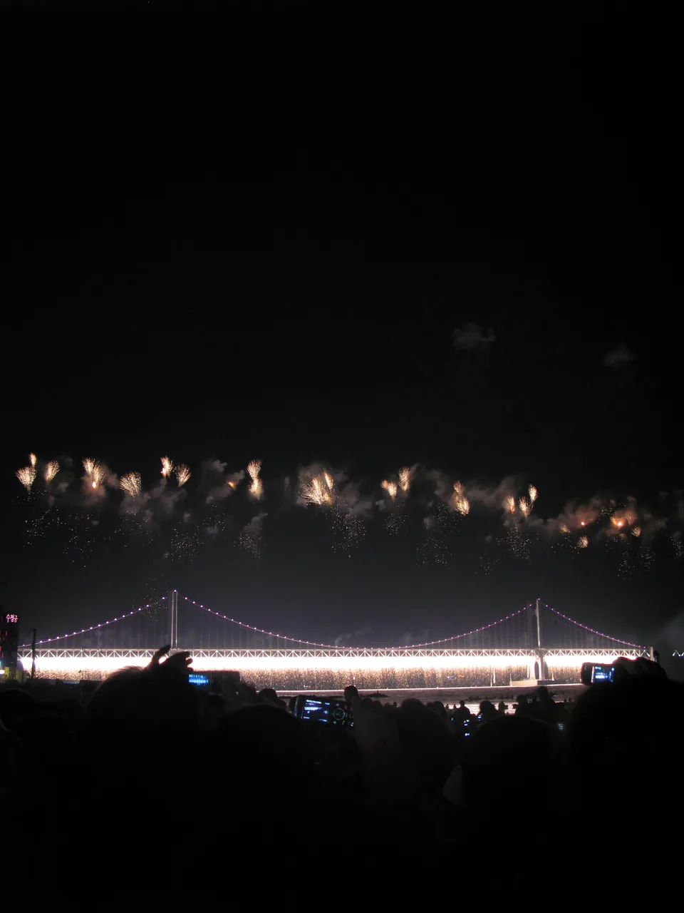 A curtain of Niagara fireworks cascading from Gwangan Bridge at the Busan Fireworks Festival