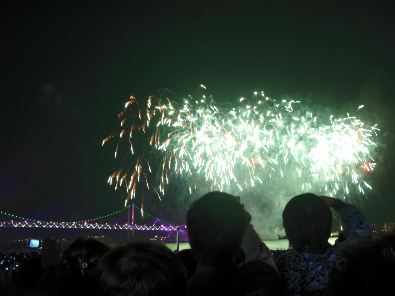 A large firework burst lighting up the night sky over Gwangalli at the Busan Fireworks Festival