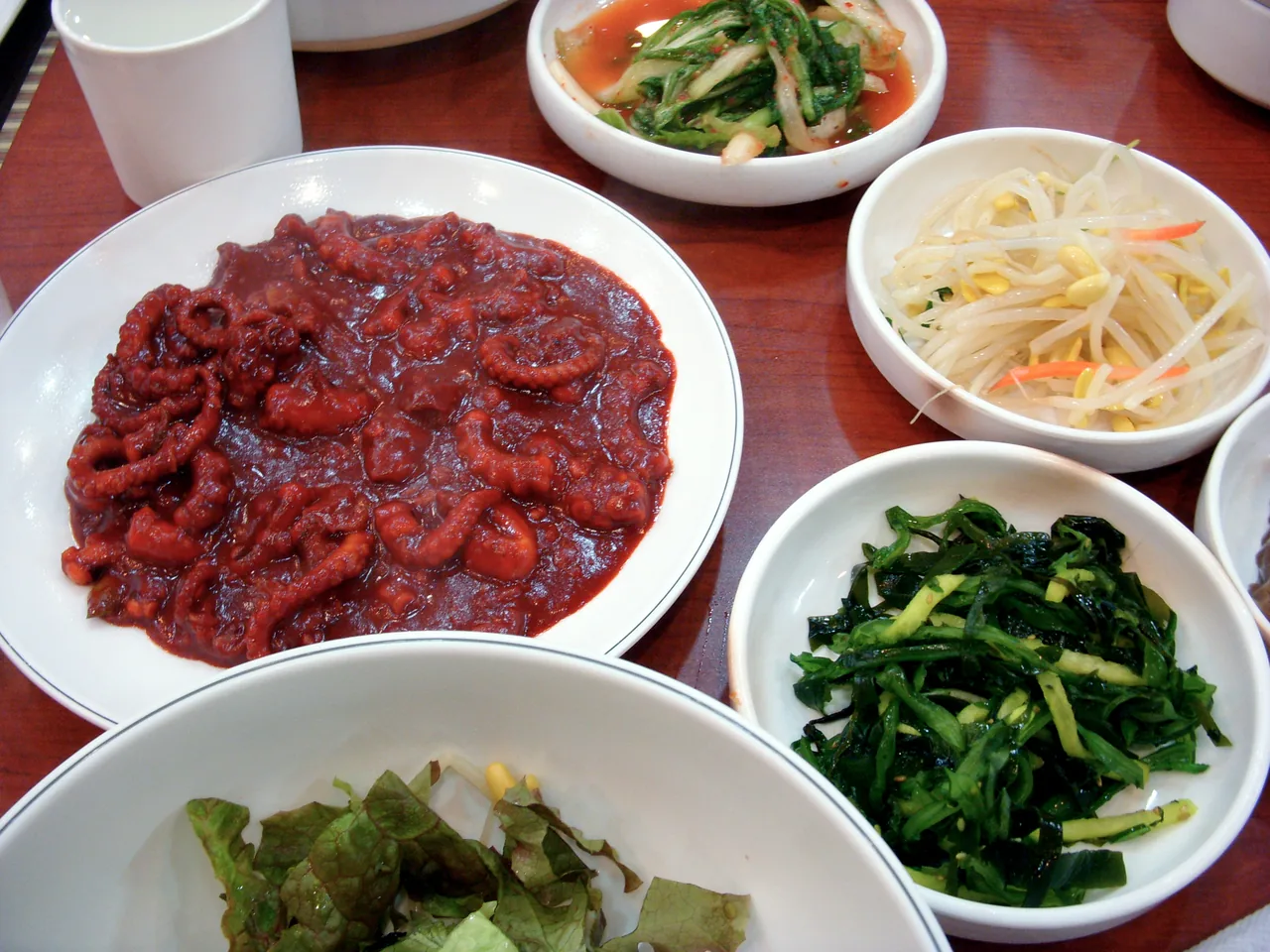 Spicy stir-fried octopus served with Korean side dishes
