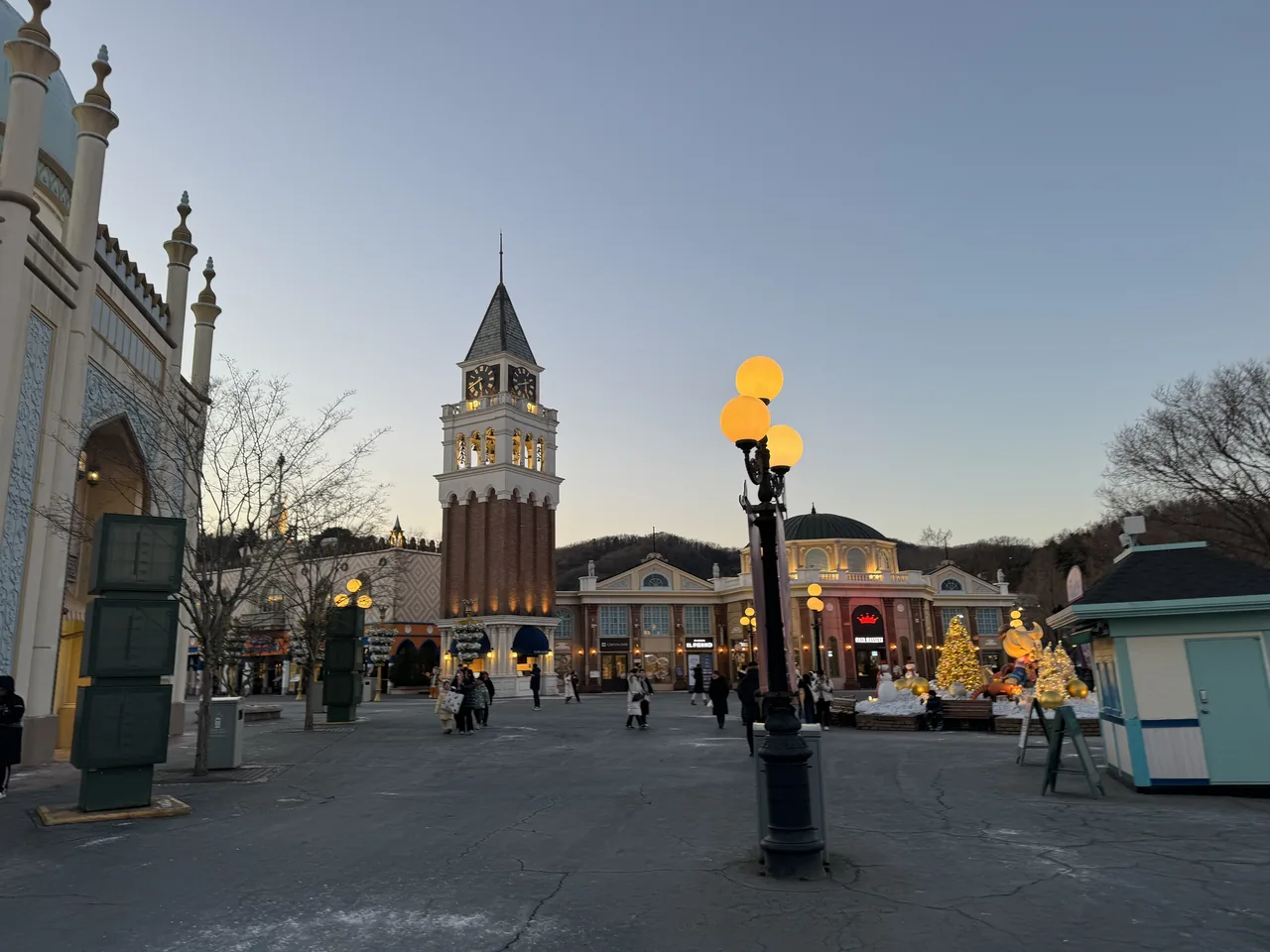 The European Adventure street and clock tower lit up at dusk at Everland