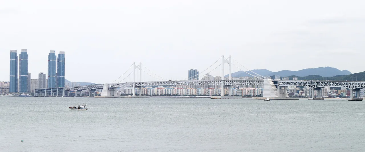 Daytime panorama of the long double-deck Gwangan Bridge spanning the bay Daytime panorama of the long double-deck Gwangan Bridge spanning the bay