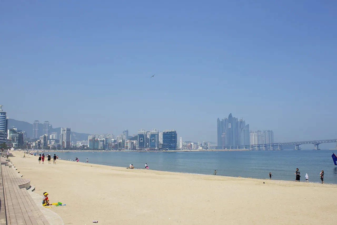 The sandy shore of Gwangalli Beach curving along the waterfront The sandy shore of Gwangalli Beach curving along the waterfront