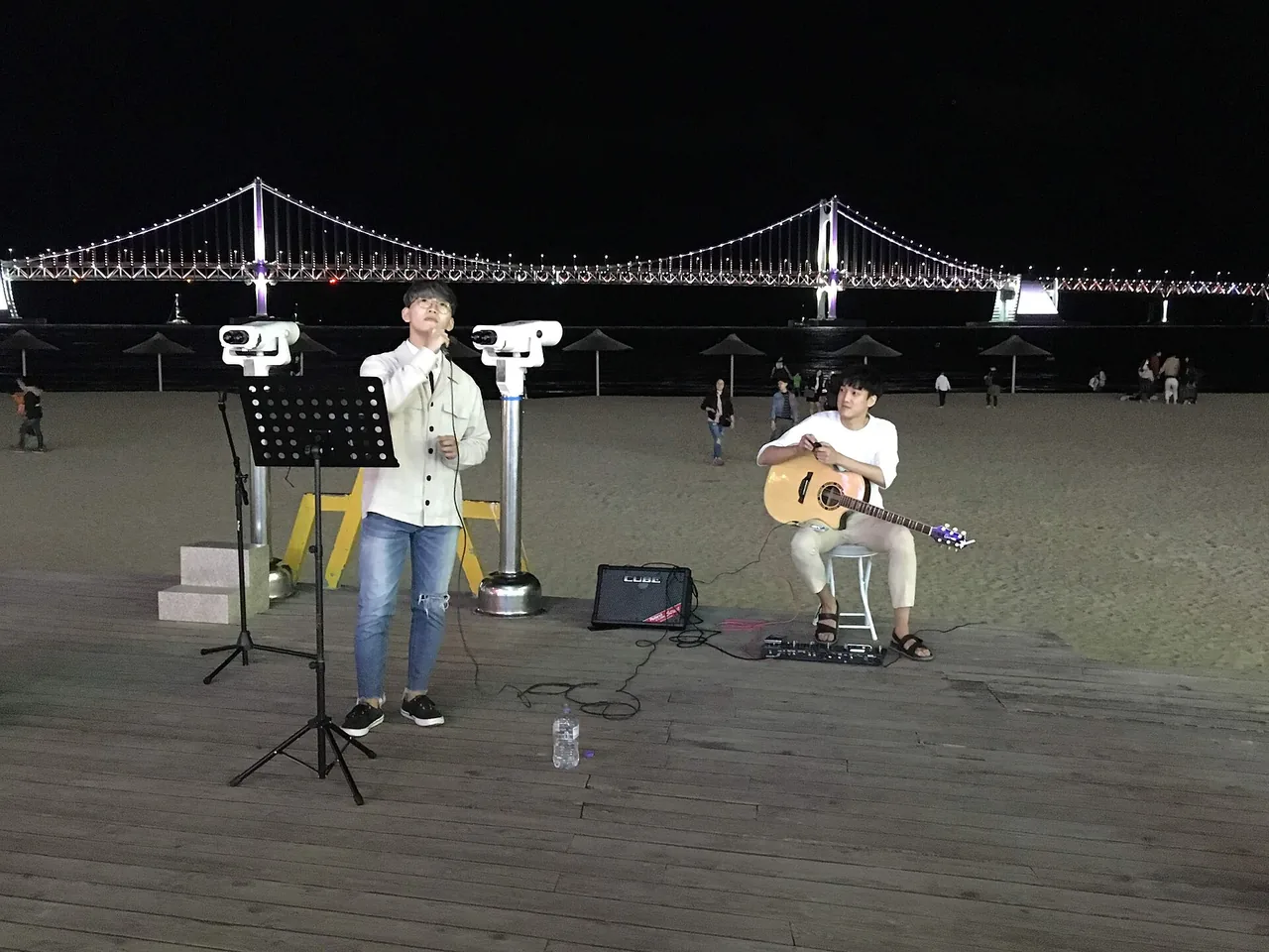 Buskers and a crowd on the Gwangalli promenade in the evening Buskers and a crowd on the Gwangalli promenade in the evening