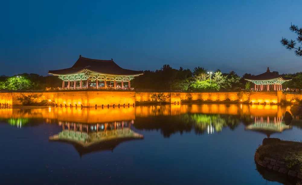 Donggung Palace and Wolji Pond lit up and reflected in the water at night in Gyeongju