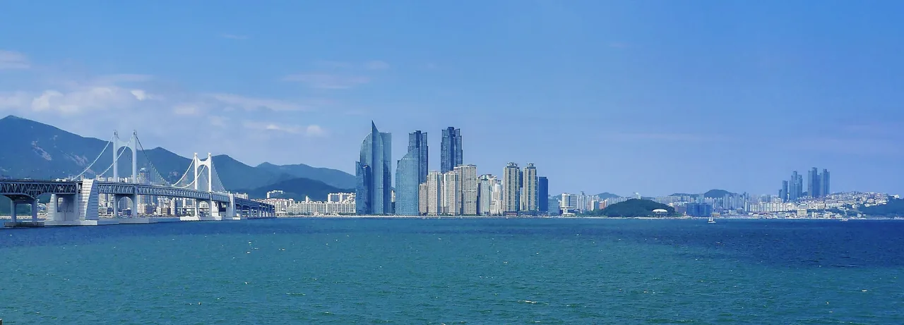 A panoramic view of Busan's coast and skyline from Igidae