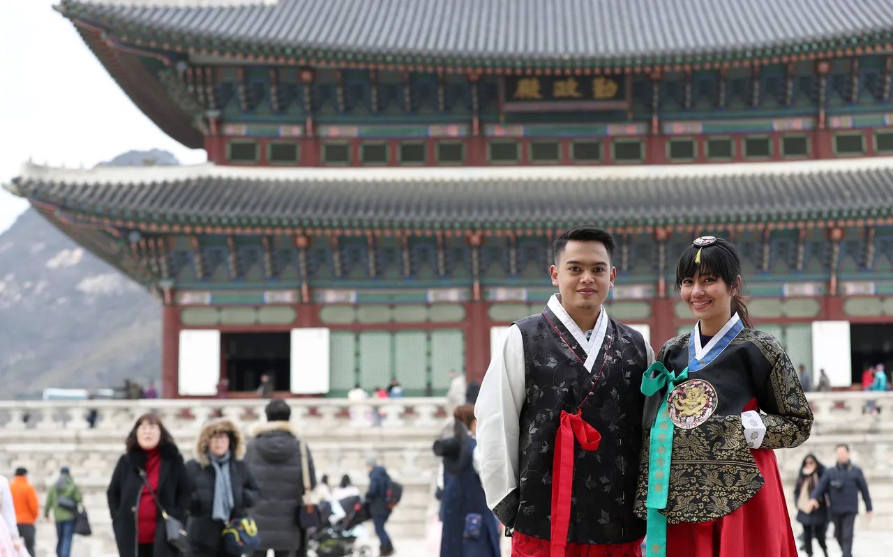 Visitors in traditional hanbok at Gyeongbokgung Palace in Seoul
