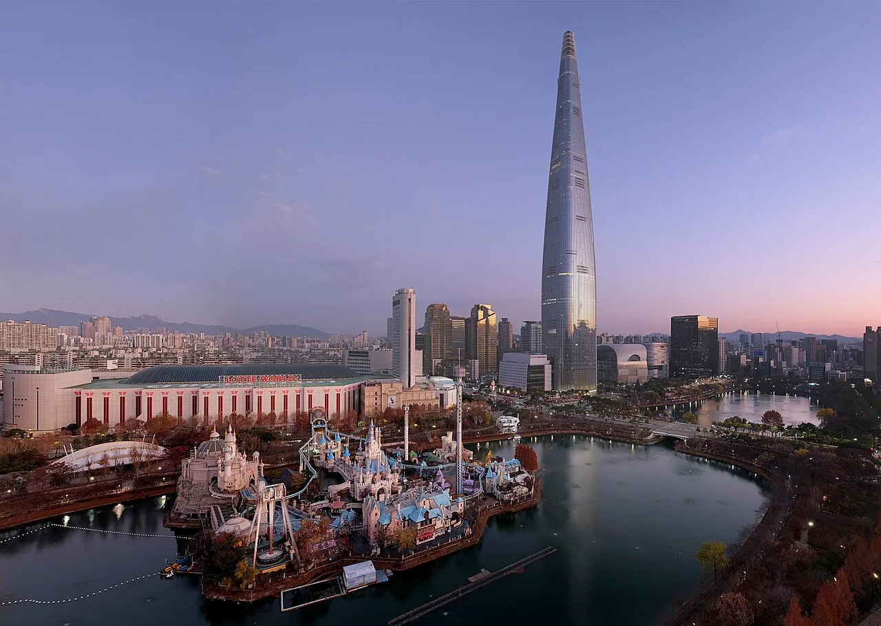 Dawn aerial view of Lotte World Tower and the Magic Island castle on Seokchon Lake in Seoul