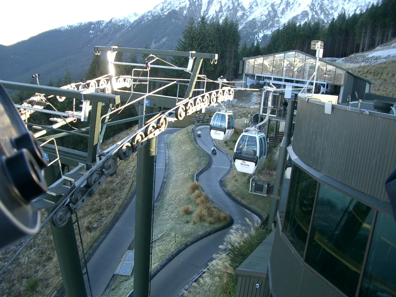 Winding Skyline Luge track and Skyride chairlift descending a green hillside