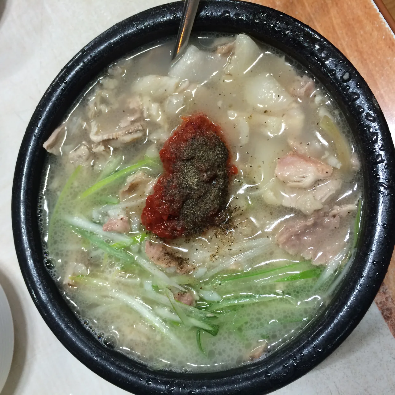 Dwaeji-gukbap topped with red dadaegi spicy seasoning paste