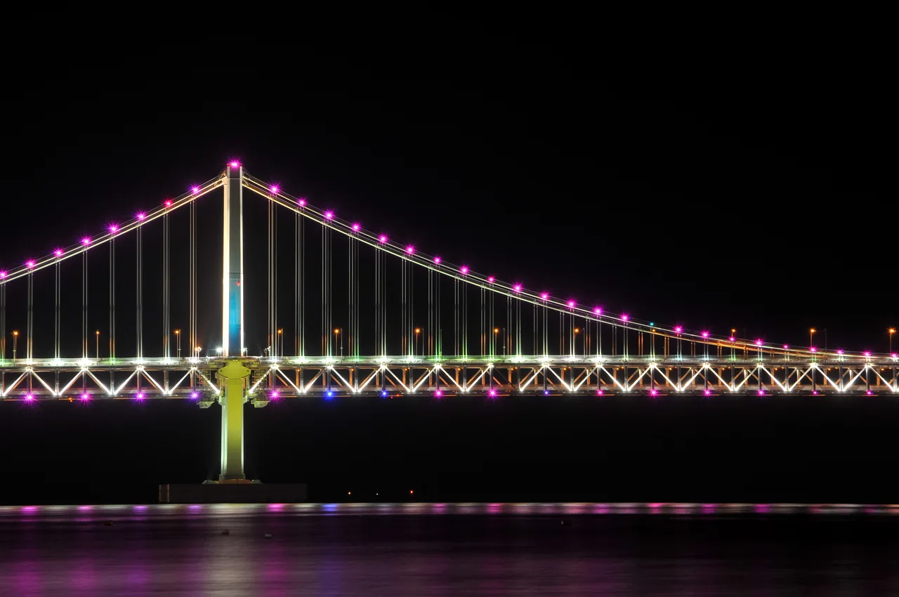 Gwangalli Beach at night facing the illuminated Gwangan Bridge in Busan Gwangalli Beach at night facing the illuminated Gwangan Bridge in Busan