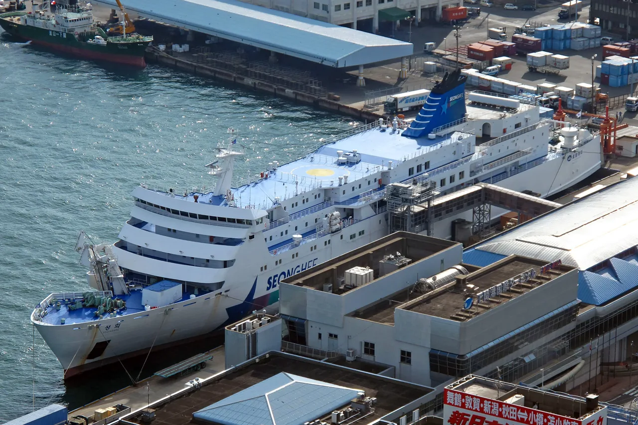 The Korean-flagged ferry Seong Hee at the quayside seen from above, the name SEONG HEE painted along the side of the hull