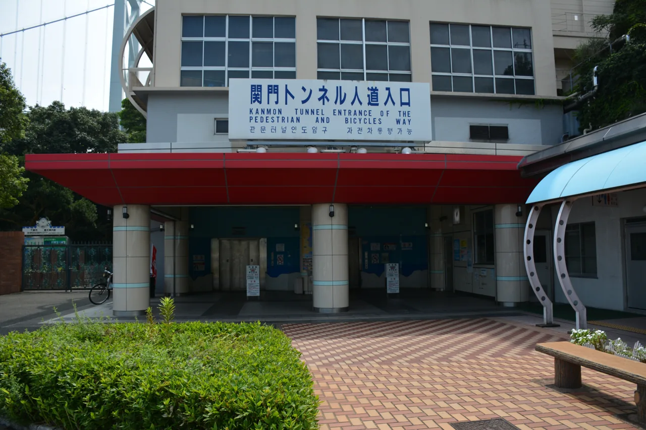 The entrance building of the Kanmon Tunnel pedestrian way, with the Japanese sign for the pedestrian entrance mounted on the wall