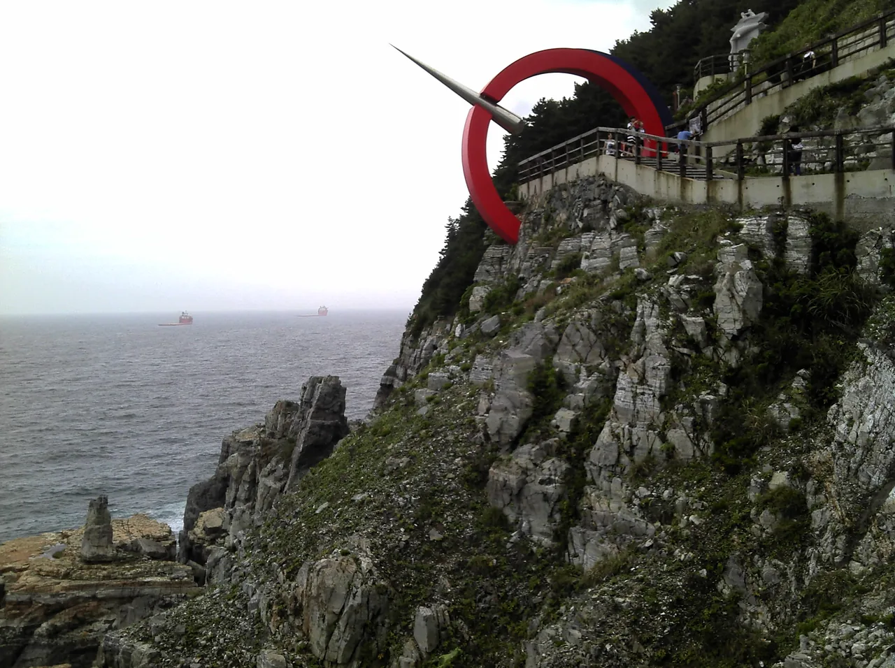 Taejongdae sea cliffs and the coastline seen from the Yeongdo Lighthouse in Busan Taejongdae sea cliffs and the coastline seen from the Yeongdo Lighthouse in Busan