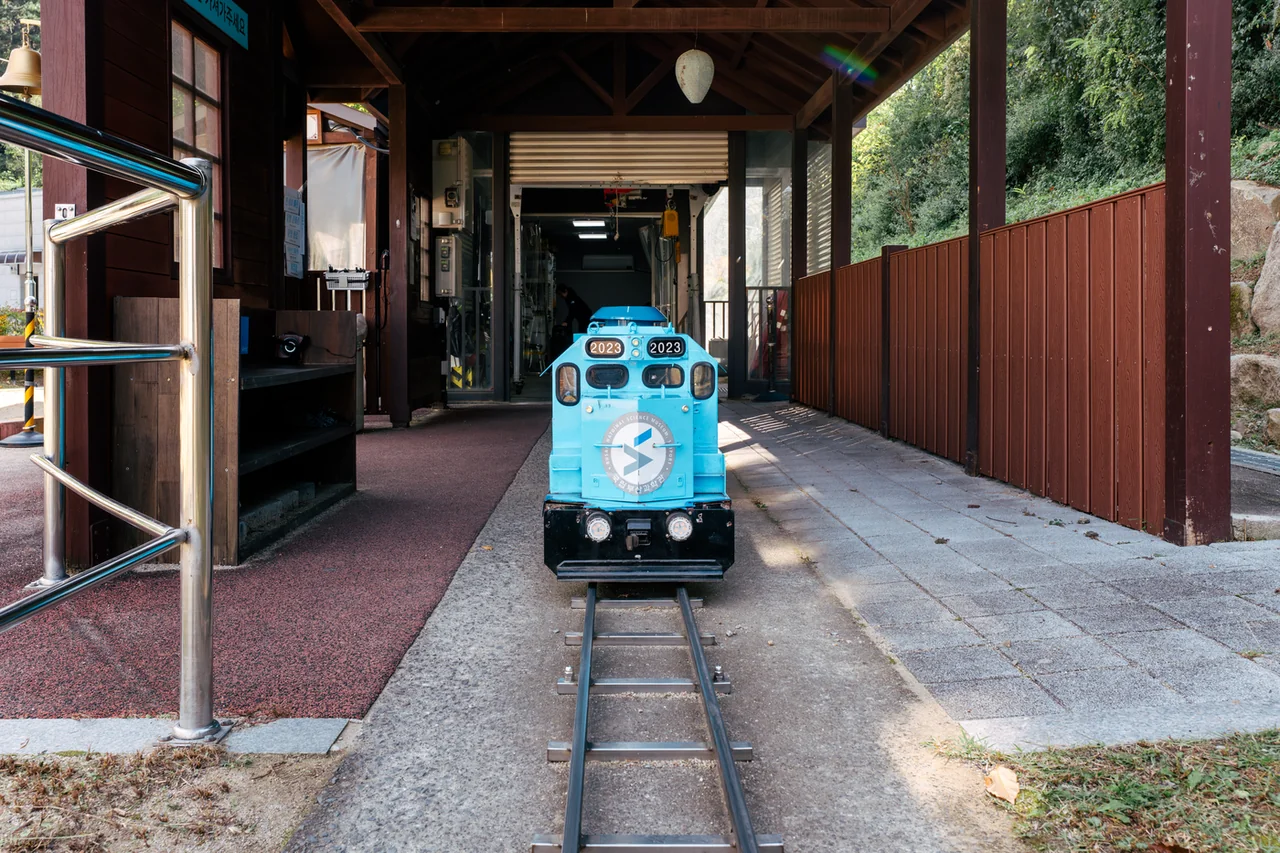 The small blue train outside Busan National Science Museum