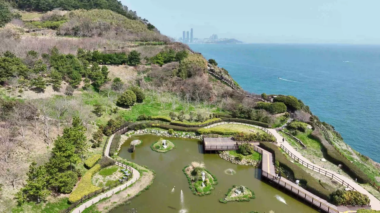 Aerial view of the pond and walkways at Oryukdo Sunrise Park beside the sea
