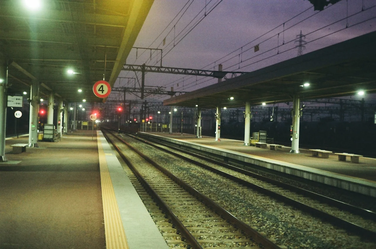 Lit platform and tracks at Taehwagang station on the Donghae line at night