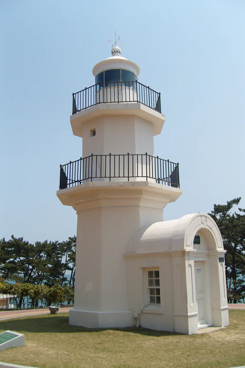 The squat round original Ulgi lighthouse tower with two levels of railing