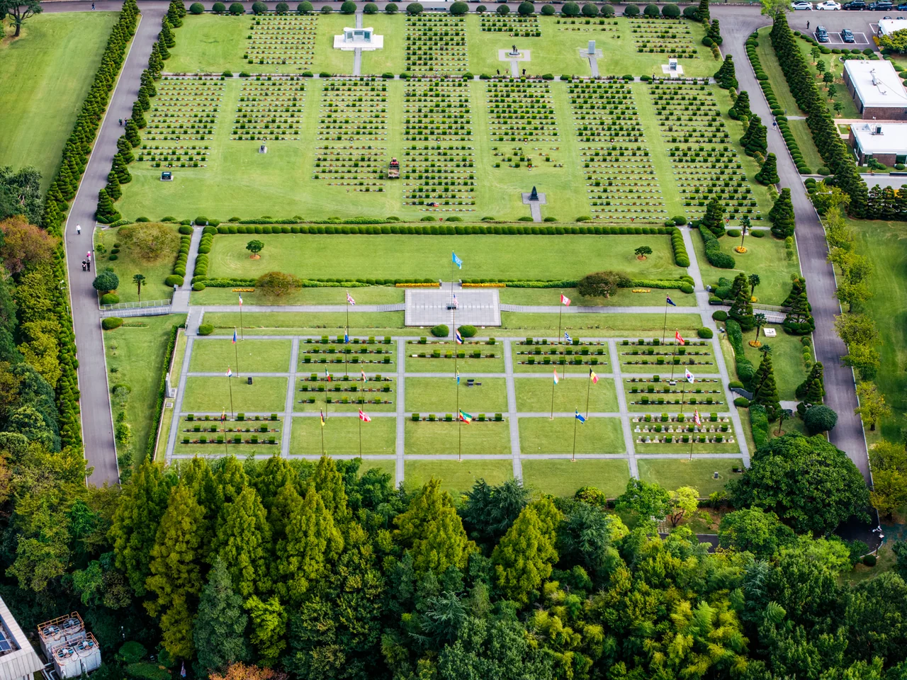 Aerial view of the UN Memorial Cemetery in Busan with the city behind