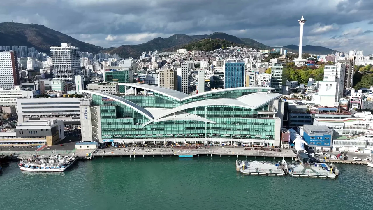 The Jagalchi market building on the waterfront with Busan Tower behind it