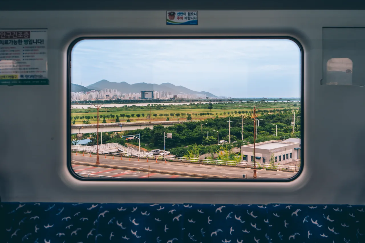 A river and the city seen through a train window